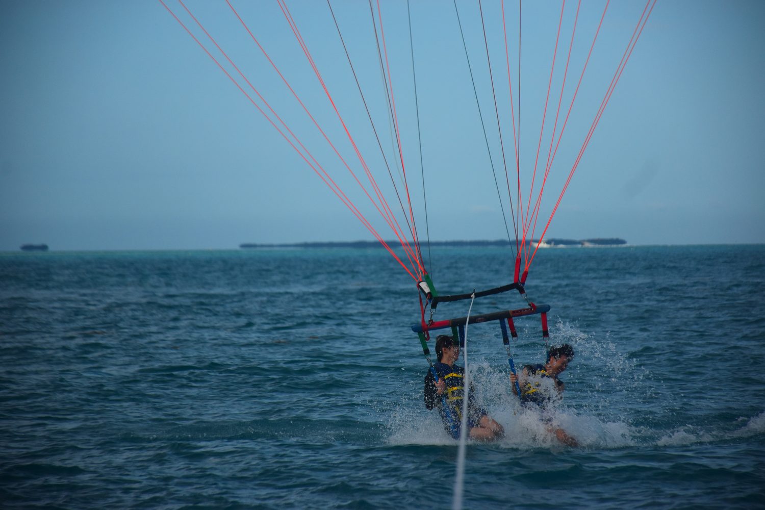 Jimmy and a friend parasailing over the sea in Key West