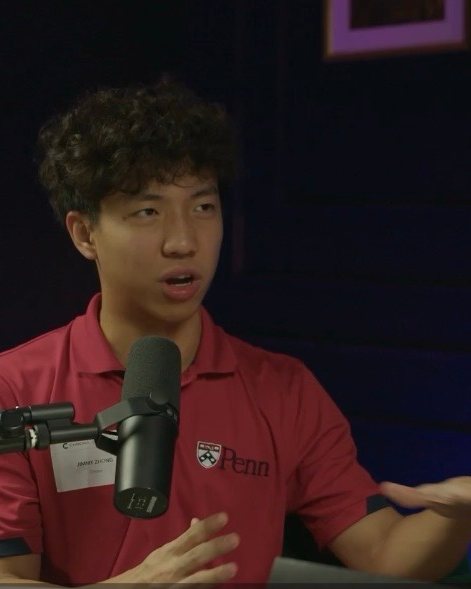 Jimmy speaking into a microphone while interviewing an AI educator on a podcast